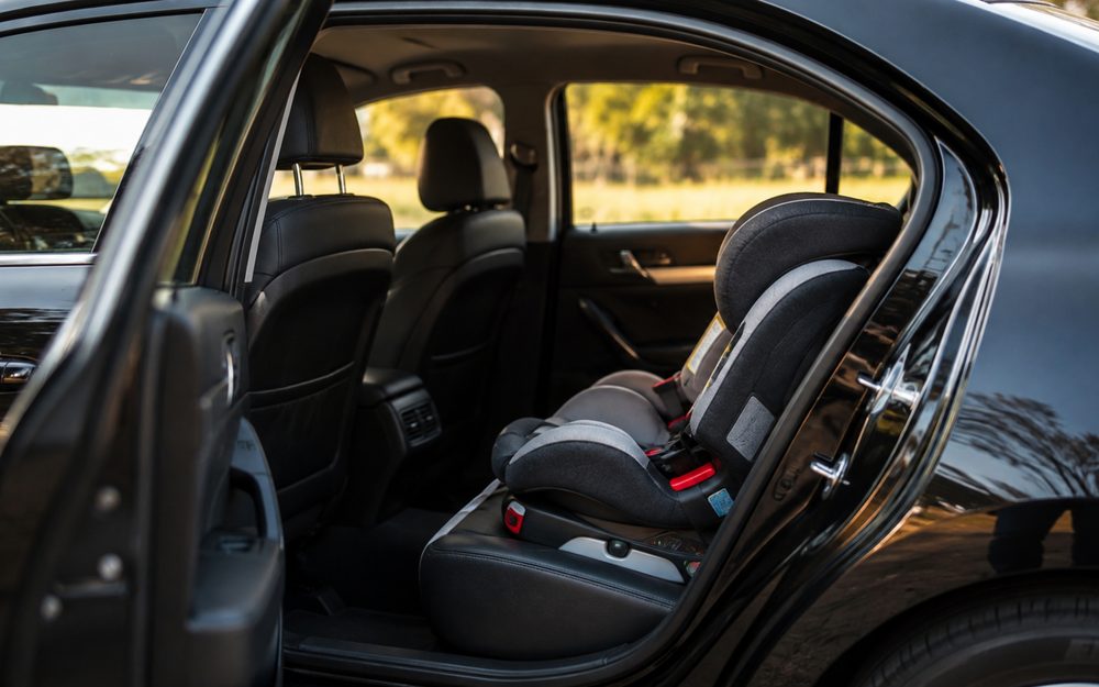 Child seat fitted in the back of a taxi